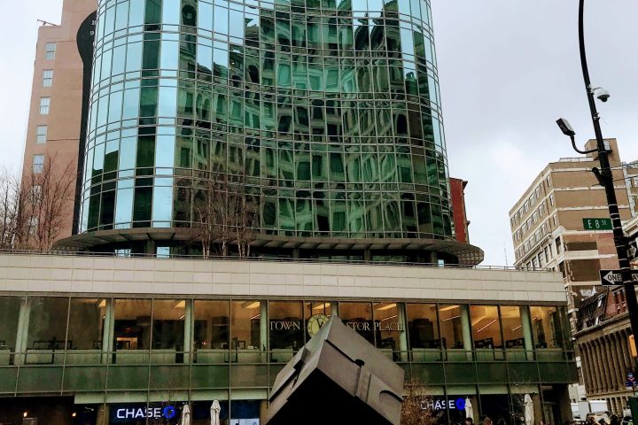 a group of people standing in front of a tall building